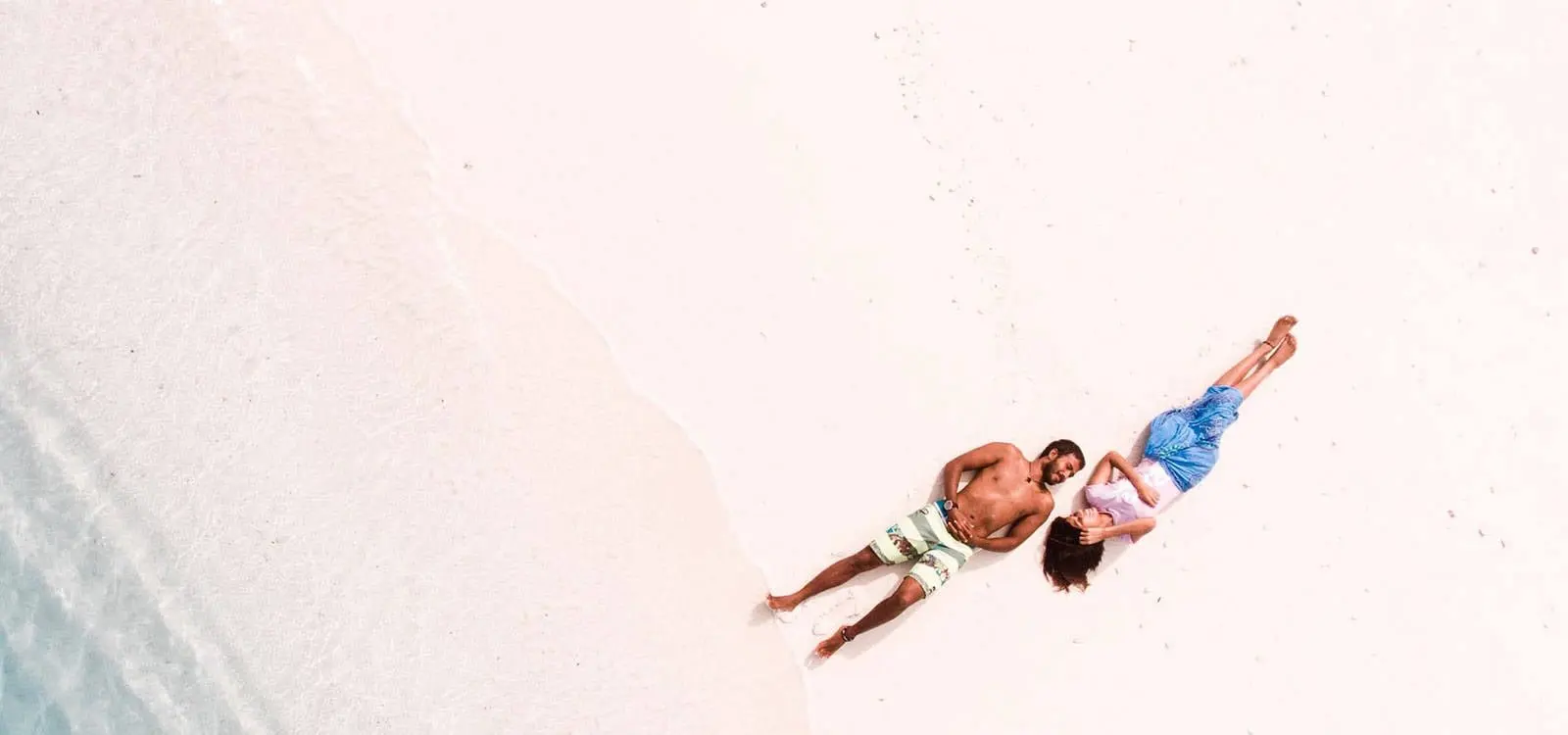 A couple enjoying a relaxing day on a white-sand beach